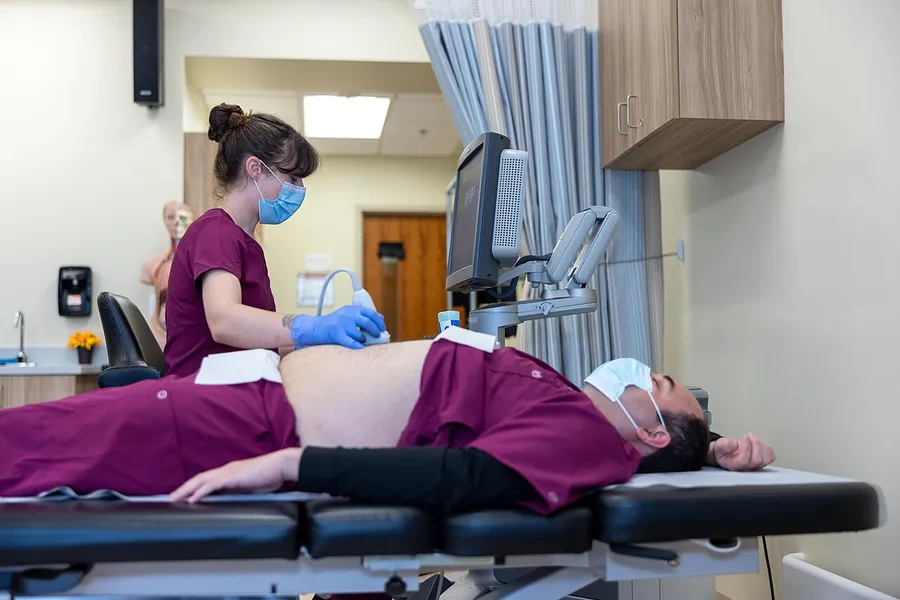 Sonography students using a donated ultrasound system